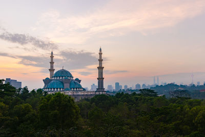 Federal territory mosque against sky during sunset