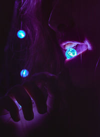 Close-up of woman holding illuminated lights