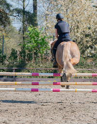 Full length of man riding horse