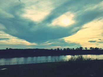 Scenic view of lake against cloudy sky