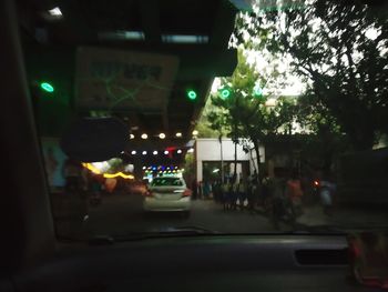 Cars on street seen through car windshield at night