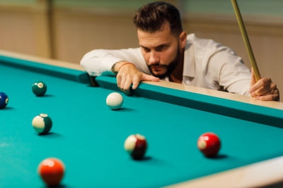 Cropped hand playing pool