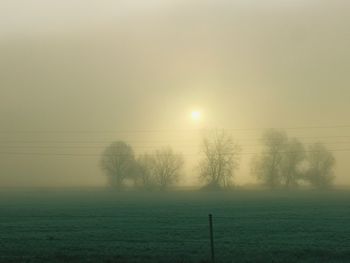 Scenic view of field against sky during winter