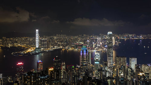 Illuminated cityscape against sky at night