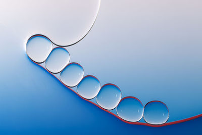 Low angle view of balloons against blue sky