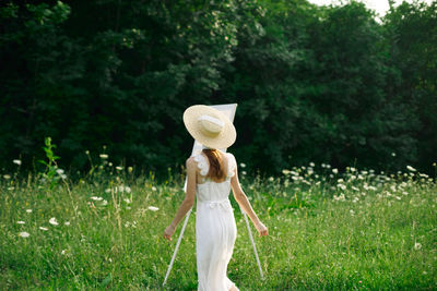 Person holding umbrella on field