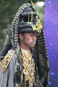 Man in traditional clothing looking away outdoors