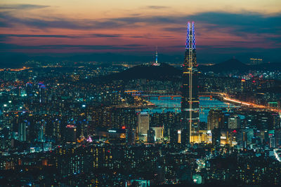 Illuminated cityscape against sky at night