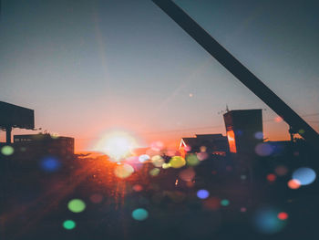 View of illuminated buildings at sunset