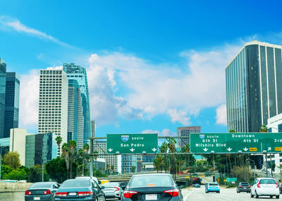 Low angle view of skyscrapers against blue sky