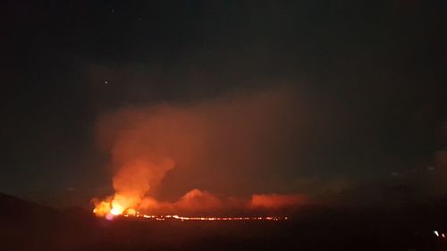 Panoramic view of firework display against sky at night