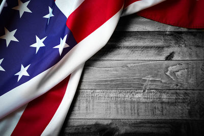 Close-up of flags against blue wall