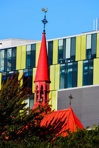 Low angle view of red building against blue sky