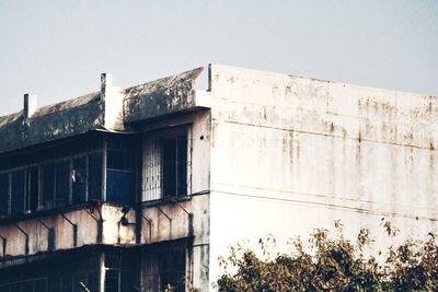 Low angle view of abandoned building against clear sky