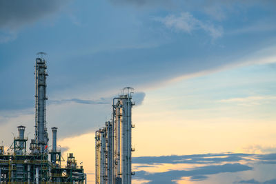 Factory against sky during sunset