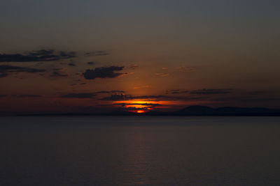 Scenic view of sea against romantic sky at sunset