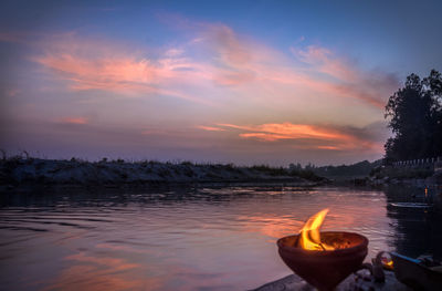 Scenic view of lake against orange sky