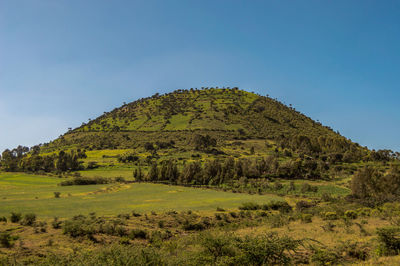 Scenic view of land against clear blue sky