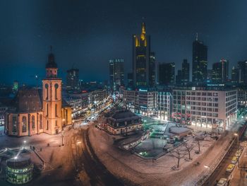 Aerial view of city lit up at night