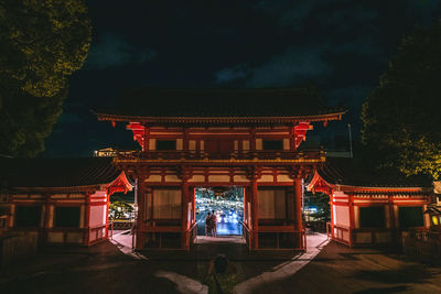 Illuminated building against sky at night