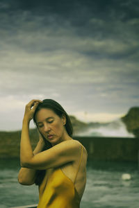 Woman with yellow dress on the basque-french coast ii