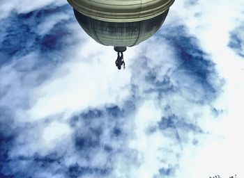 Low angle view of street light against cloudy sky