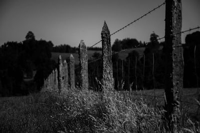 Fence on field against sky