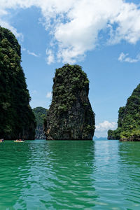 Scenic view of rocks in sea against sky