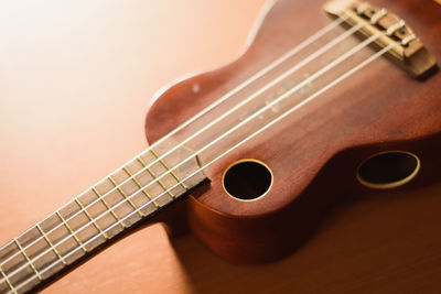 Close-up of ukulele on wooden table