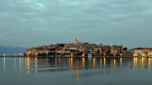 Illuminated buildings in city at dusk