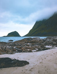 Scenic view of sea and mountains against sky