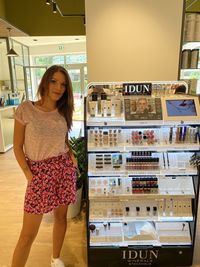 Portrait of smiling young woman standing in store