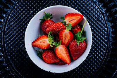 High angle view of strawberries in bowl on table