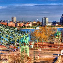 View of cityscape against cloudy sky
