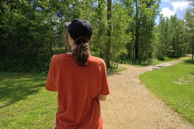 Rear view of man standing in forest