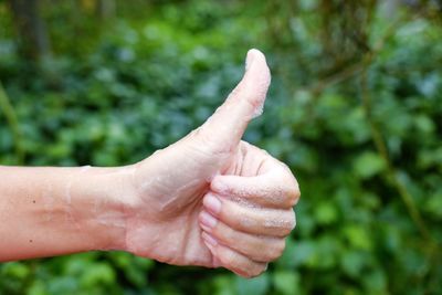 Close-up of hand showing thumbs up