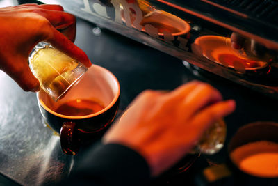 Cropped hand of barista preparing coffee