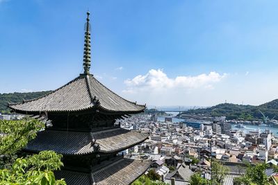 Panoramic view of buildings in city against sky