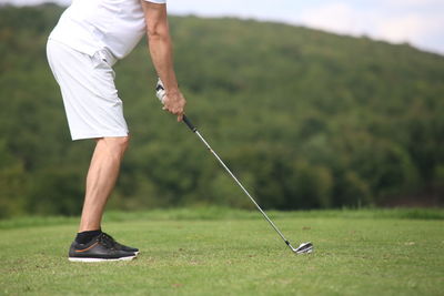 Full length of man standing on golf course