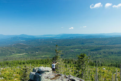 Young man stands on rock at place called dreisesselberg, located on border of austria, germany 