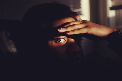 Close-up of woman with hands on head