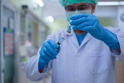 Midsection of person holding umbrella