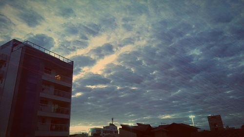 Low angle view of building against cloudy sky