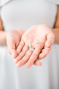 Close-up of woman holding necklace