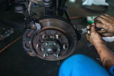 Midsection of man repairing car