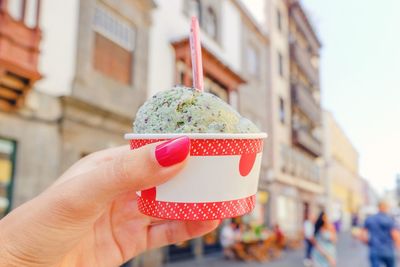 Close-up of hand holding ice cream cone