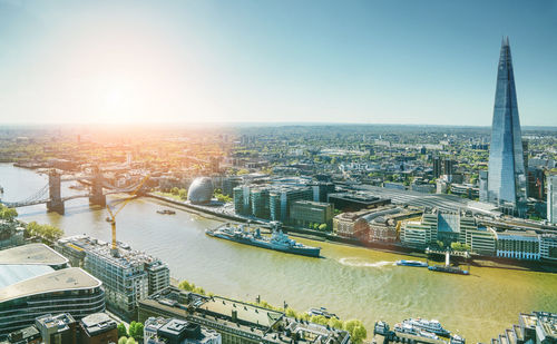 Aerial view of bridge over river and buildings against sky