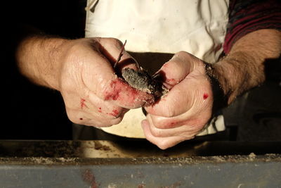 Midsection of man preparing food