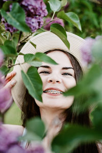 Candid portrait of beautiful happy smiling young woman with braces in summer park. outdoor portrait