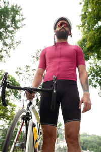 Rear view of man standing against trees